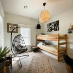 A wicker swinging chair hangs in the Jungle Room.