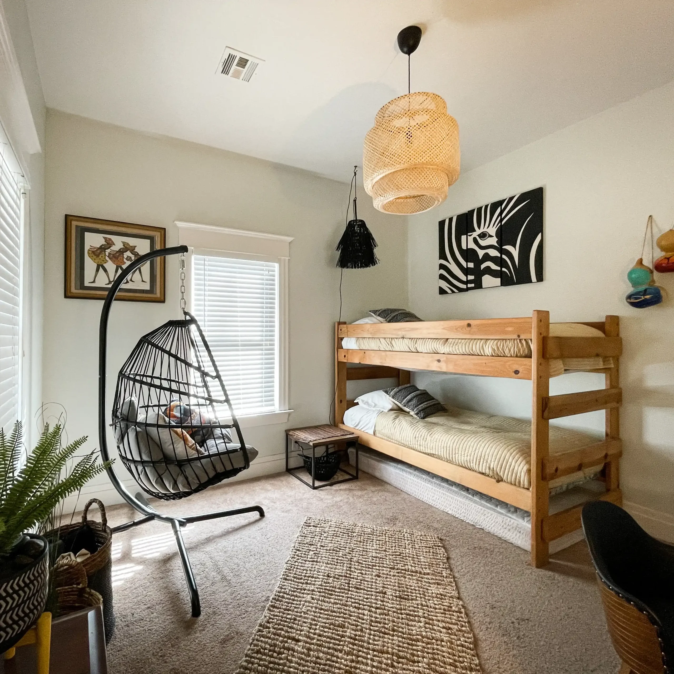 A wicker swinging chair hangs in the Jungle Room.
