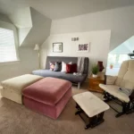 A California King sits across from a futon couch and two Ottomans.